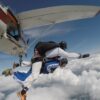 Packages Exciting tandem skydive adventure captured in midair, above the clouds.